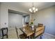 Dining room with rustic wooden table, chandelier and plenty of natural light creates a welcoming atmosphere at 6811 W Darrel Rd, Laveen, AZ 85339
