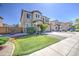 Charming two-story home featuring a well-manicured lawn, desert landscaping, and a spacious driveway at 6811 W Darrel Rd, Laveen, AZ 85339