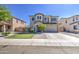 Beautiful two-story house with a well-kept lawn, desert landscape and a spacious two-car garage at 6811 W Darrel Rd, Laveen, AZ 85339