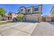 Desirable two-story home with desert landscaping and a spacious driveway leading to a two-car garage at 6811 W Darrel Rd, Laveen, AZ 85339