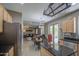 Open-concept kitchen flows into dining area, featuring stainless steel fridge and granite countertops at 6811 W Darrel Rd, Laveen, AZ 85339
