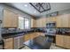 Well-lit kitchen boasts granite countertops, stainless steel appliances, and ample cabinet space at 6811 W Darrel Rd, Laveen, AZ 85339