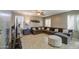 Spacious living room with a large sectional couch, decorative ottoman, and ceiling fan at 6811 W Darrel Rd, Laveen, AZ 85339