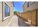 Paver side yard featuring a tree and a view between the houses into the community at 6811 W Darrel Rd, Laveen, AZ 85339