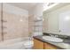 A clean bathroom with tiled shower and vanity at 6901 W Mackenzie Dr # 1287, Phoenix, AZ 85033