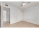 A clean bedroom featuring neutral walls, a ceiling fan, a tiled floor, and a sliding door closet at 6901 W Mackenzie Dr # 1287, Phoenix, AZ 85033