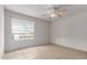 Bright bedroom with neutral walls, a ceiling fan, and a window at 6901 W Mackenzie Dr # 1287, Phoenix, AZ 85033