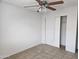 Bedroom with tile flooring, a ceiling fan, and closet with sliding doors at 6901 W Mackenzie Dr # 1287, Phoenix, AZ 85033