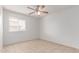 A bright bedroom with neutral walls, a ceiling fan, and natural light from a window at 6901 W Mackenzie Dr # 1287, Phoenix, AZ 85033