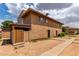 Exterior angle of the building features a back patio, walkway and simple xeriscaping at 6901 W Mackenzie Dr # 1287, Phoenix, AZ 85033