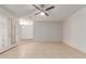 Bright living room with neutral walls, tile flooring, and glass patio doors at 6901 W Mackenzie Dr # 1287, Phoenix, AZ 85033