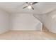 Living room features neutral walls, tile flooring, and access to the stairs at 6901 W Mackenzie Dr # 1287, Phoenix, AZ 85033