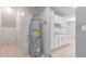Spacious utility room with hot water tank and cabinetry at 6901 W Mackenzie Dr # 1287, Phoenix, AZ 85033