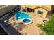 Aerial view of a sparkling pool and spa surrounded by a desert landscaped yard, and covered patio at 8830 S 20Th S Pl, Phoenix, AZ 85042
