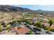 An aerial view showcases desert community nestled in the mountains, featuring single Gathering homes and desert landscaping at 8830 S 20Th S Pl, Phoenix, AZ 85042