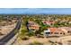 An aerial view of a desert neighborhood with a home featuring solar panels, a private pool, and mountain views at 8830 S 20Th S Pl, Phoenix, AZ 85042