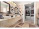 Lovely bathroom with double sinks, decorative tile and an open closet with drawers at 8830 S 20Th S Pl, Phoenix, AZ 85042