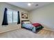 Cozy bedroom with a comfy bed, neutral carpet, natural light, and a modern decor offers a relaxing retreat at 8830 S 20Th S Pl, Phoenix, AZ 85042