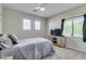 Well-lit bedroom with two windows, a comfortable bed, a TV, and neutral carpet offers a relaxing and inviting space at 8830 S 20Th S Pl, Phoenix, AZ 85042