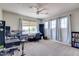 Versatile bedroom with large windows, a ceiling fan, neutral walls and carpet offers customizable functionality at 8830 S 20Th S Pl, Phoenix, AZ 85042
