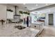 Bright open kitchen with white cabinets, stone countertops, a large island, and stainless appliances at 8830 S 20Th S Pl, Phoenix, AZ 85042