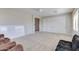 Spacious living room featuring a ceiling fan, neutral walls, neutral carpet, and sliding closet doors for flexible usage at 8830 S 20Th S Pl, Phoenix, AZ 85042