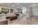Open-concept living space with a cozy sofa and seamless flow into a modern kitchen with a large island at 8830 S 20Th S Pl, Phoenix, AZ 85042