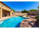 Stunning backyard featuring a sparkling pool, a tanning shelf, a spa, lush greenery, and mountain views at 8830 S 20Th S Pl, Phoenix, AZ 85042