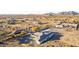 Expansive aerial view of a desert home with a gravel yard, showcasing its architectural design and surrounding landscape at 9357 W Canyon Verde Dr, Casa Grande, AZ 85194