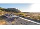 A desert home with mountain views, desert landscaping, and a long concrete driveway at 9357 W Canyon Verde Dr, Casa Grande, AZ 85194
