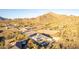 Panoramic aerial view of a desert home set against a majestic mountain backdrop, highlighting the serene desert location at 9357 W Canyon Verde Dr, Casa Grande, AZ 85194