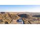 Picturesque aerial view of a desert home nestled near mountains, offering privacy and panoramic vistas of the surrounding landscape at 9357 W Canyon Verde Dr, Casa Grande, AZ 85194