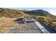 Aerial view of home featuring a long driveway and mountain views on a sunny day at 9357 W Canyon Verde Dr, Casa Grande, AZ 85194