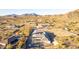Stunning aerial perspective of a desert home, nestled among trees and desert landscape with a mountain backdrop at 9357 W Canyon Verde Dr, Casa Grande, AZ 85194
