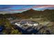 An aerial view showing a desert home surrounded by mountains, set amongst the trees at 9357 W Canyon Verde Dr, Casa Grande, AZ 85194