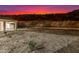 Twilight shot of back exterior featuring desert landscaping and mountain views at 9357 W Canyon Verde Dr, Casa Grande, AZ 85194