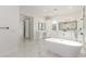 Bright bathroom featuring dual vanities, a soaking tub, and a walk-in closet at 9357 W Canyon Verde Dr, Casa Grande, AZ 85194