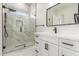 Chic bathroom featuring shower with marble tile, vanity with black fixtures, and marble flooring at 9357 W Canyon Verde Dr, Casa Grande, AZ 85194