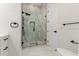 Stylish bathroom with a marble-tiled shower, a vanity with black fixtures, and marble flooring at 9357 W Canyon Verde Dr, Casa Grande, AZ 85194