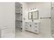 Bathroom featuring a white vanity, black hardware, a large mirror, and marble floors at 9357 W Canyon Verde Dr, Casa Grande, AZ 85194