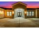 Arched entrance with iron double doors, and concrete driveway with desert landscaping at 9357 W Canyon Verde Dr, Casa Grande, AZ 85194