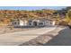 A beautiful desert home featuring large windows and a spacious driveway on a sunny day at 9357 W Canyon Verde Dr, Casa Grande, AZ 85194