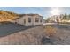 Rear view of single-story home with desert landscaping and a hill backdrop at 9357 W Canyon Verde Dr, Casa Grande, AZ 85194