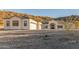 Single-story home with desert landscaping, three-car garage, and neutral stucco at 9357 W Canyon Verde Dr, Casa Grande, AZ 85194