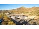 Breathtaking view of a desert house with scenic mountain backdrops and serene desert landscaping at 9357 W Canyon Verde Dr, Casa Grande, AZ 85194