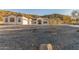 A gorgeous home featuring a big concrete driveway, a desert landscape, and a three-car garage at 9357 W Canyon Verde Dr, Casa Grande, AZ 85194