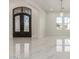 Bright foyer with ornate iron double doors and marble floors at 9357 W Canyon Verde Dr, Casa Grande, AZ 85194
