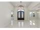 Bright foyer featuring marble floors, a decorative chandelier, and an ornate iron front door at 9357 W Canyon Verde Dr, Casa Grande, AZ 85194