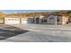 A spacious three-car garage, modern windows, and a concrete driveway on a sunny day at 9357 W Canyon Verde Dr, Casa Grande, AZ 85194