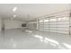 Bright and spacious three-car garage with epoxy flooring, white walls, and natural lighting at 9357 W Canyon Verde Dr, Casa Grande, AZ 85194